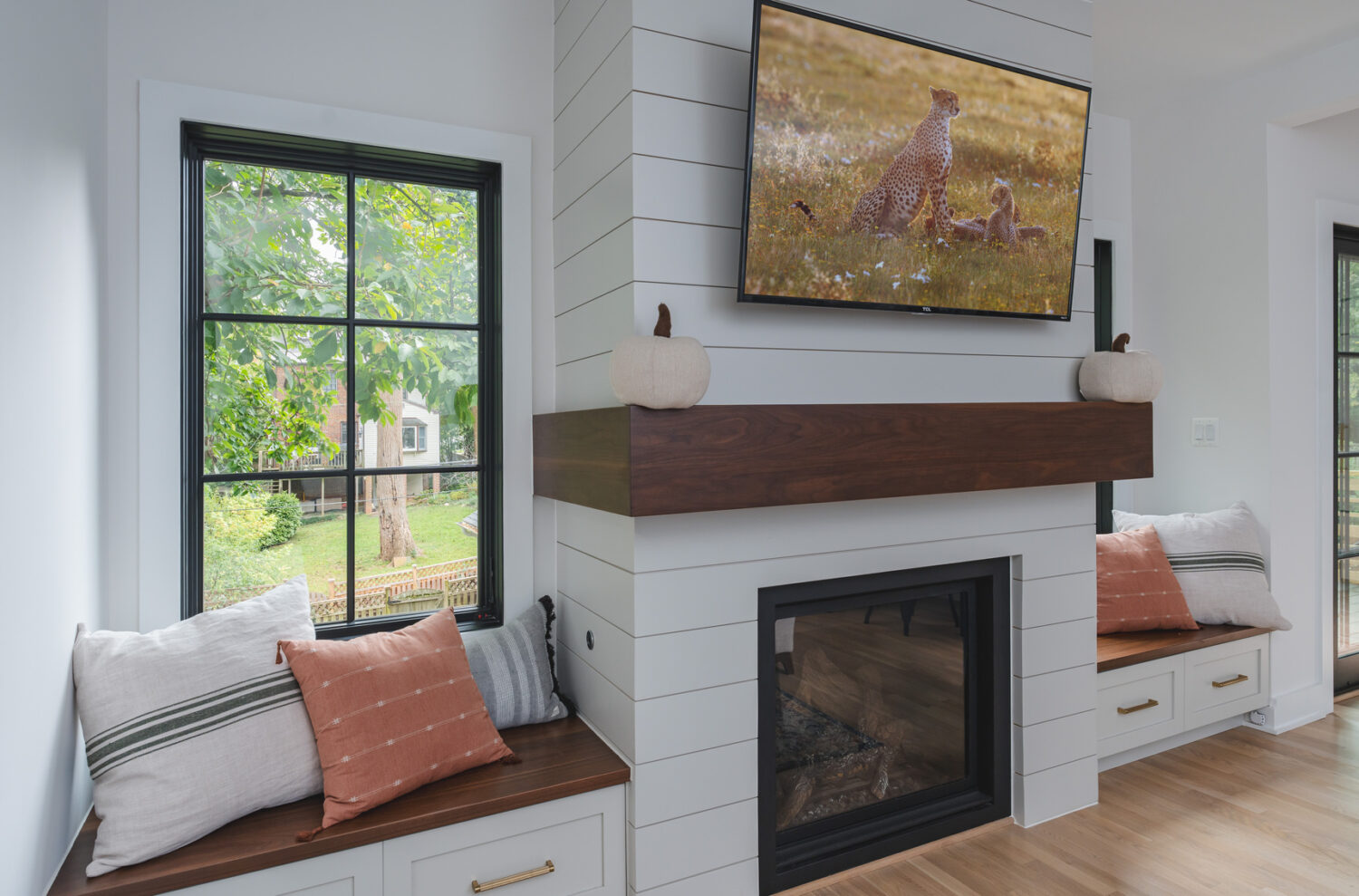 Custom built-in fireplace with shiplap and natural wood cabinetry in home addition for Washington DC home renovation by Hammer Design Build