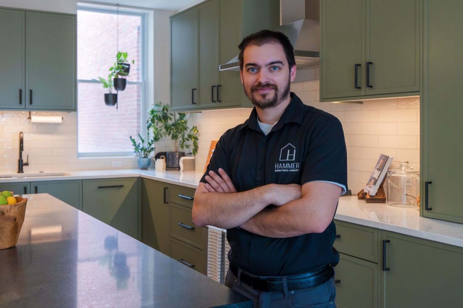 Hammer Design Build Remodel project management team leader standing in newly completed custom kitchen renovation in Washington, DC