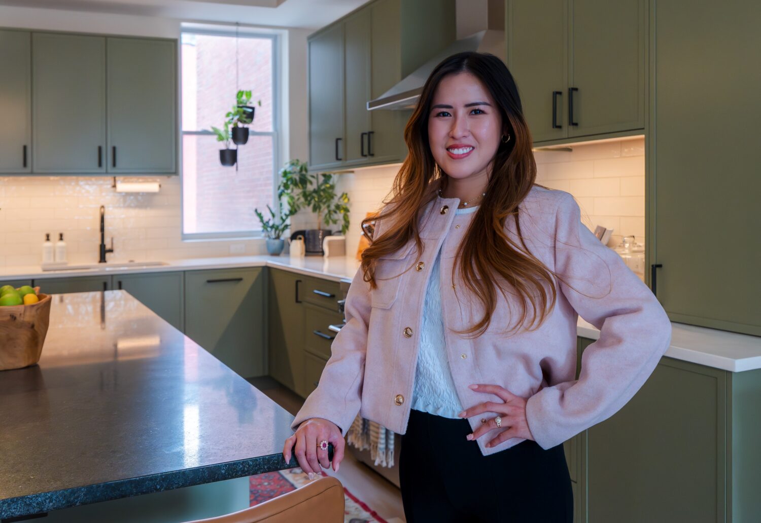Hammer Design Build Remodel design team leader standing in newly completed custom kitchen renovation in Washington, DC