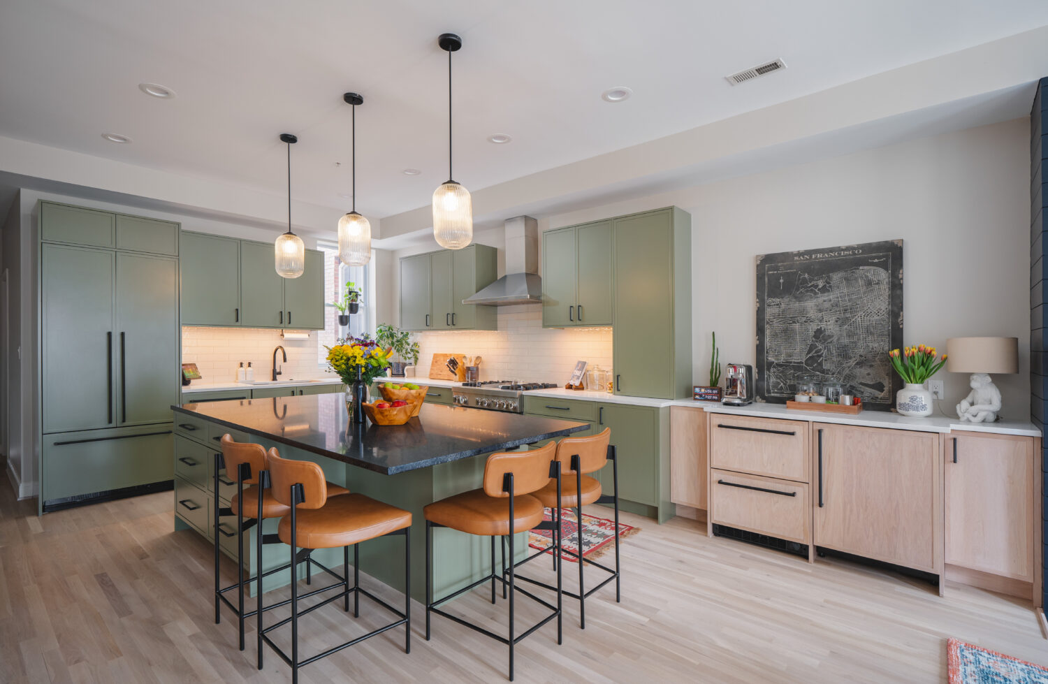 Custom-built white oak and green kitchen cabinets with brass hardware in Washington DC remodel