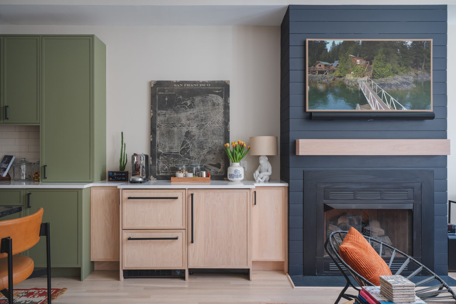 Custom built-in dry bar with natural wood cabinetry adjacent to navy blue shiplap fireplace wall in Washington DC home remodel by Hammer Design Build Remodel